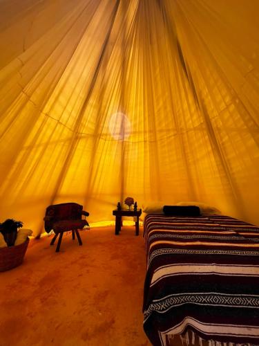 a bedroom with two beds in a tent at Tipis Cuetzalan in Cuetzalán del Progreso