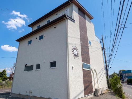 a building with a painting on the side of it at Kawaguchiko Villa LaLuce in Fujikawaguchiko