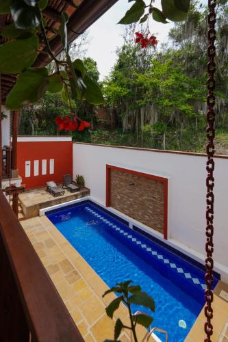 a swimming pool in the middle of a house at Hotel Tierra Roja in Barichara