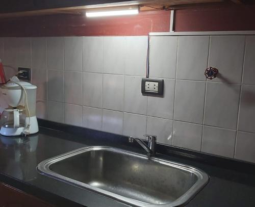 a kitchen counter with a sink in a kitchen at Casa en La Punta in La Punta