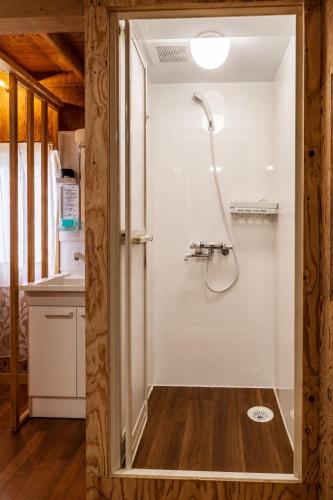 a bathroom with a shower in a room at Alley Oop Hakuba in Hakuba