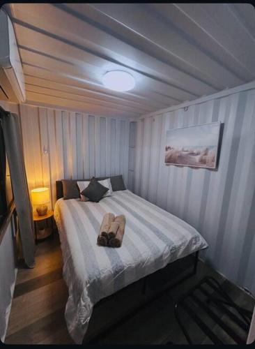 a bedroom with a bed with a hat on it at Outback Getaway Home in Mount Isa
