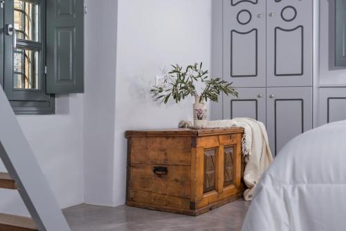 a bedroom with a wooden dresser with a plant on it at Kastro Mansion in Pirgos