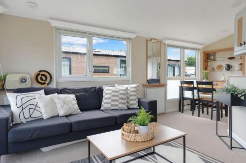 a living room with a blue couch and a table at The Chester-2 bed Static Caravan in Oxnam