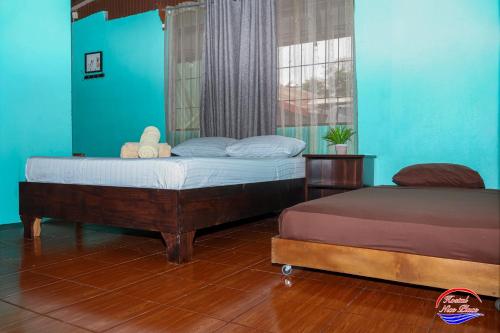 a bedroom with two beds and a window at Nice Place Hostel in Fortuna