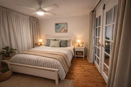 a bedroom with a bed and a ceiling fan at Gosford Retreat in Gosford