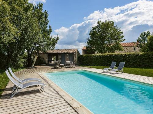 a swimming pool with two chairs and a house at Holiday Home Saint-Laurent Pool Retreat in La Chapelle-Thémer