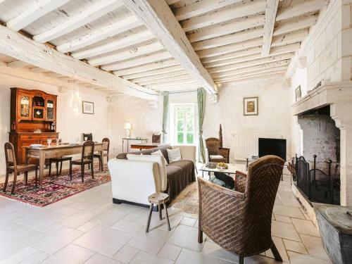 a living room with a couch and a fireplace at Holiday Home Saint-Laurent Pool Retreat in La Chapelle-Thémer