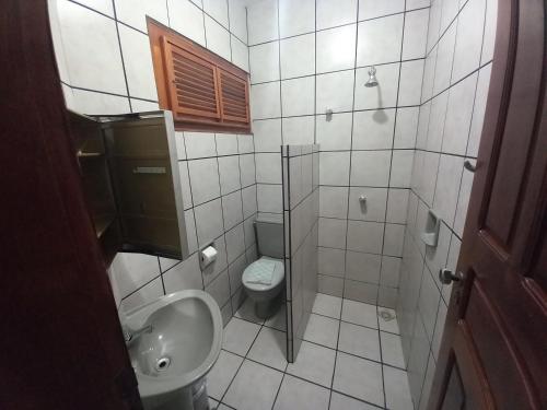 a small bathroom with a toilet and a sink at Hotel Amaro in Luis Correia