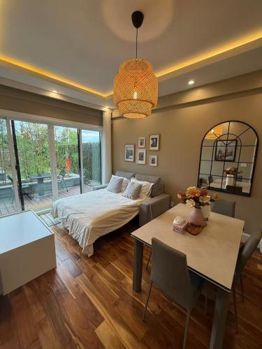 a bedroom with a bed and a table and a dining room at Sunnywood Garden in Richmond