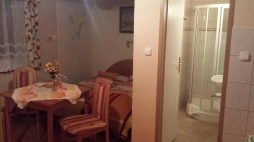 a kitchen with a table and chairs and a bathroom at Paul-S Apartman in Bad Hofgastein