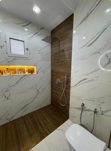a bathroom with a shower and a toilet in it at Maison dar allouche in Kelibia