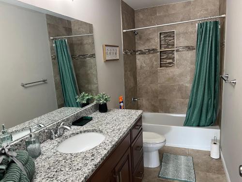 a bathroom with a sink and a toilet and a tub at Sterling Heights Retreat ! in Sterling Heights