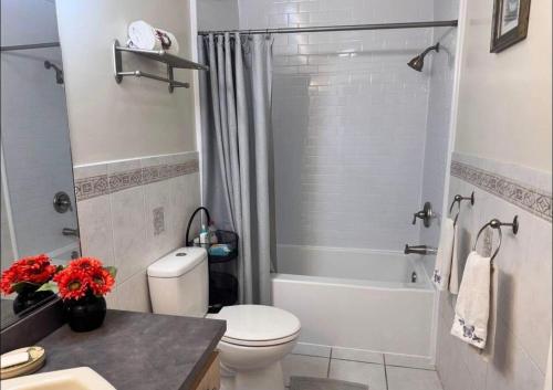 a bathroom with a toilet and a shower and a sink at NinaOCPlace in Ocean City