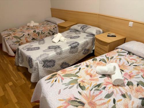 a hotel room with two beds with towels on them at Hostal Alhambra in Mocejón