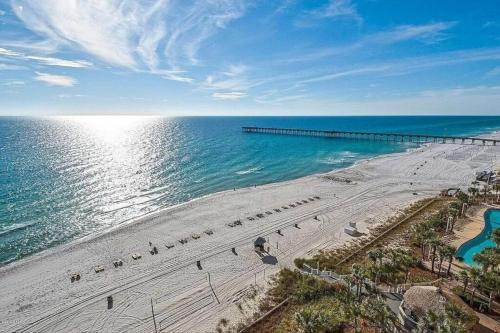 an aerial view of a beach with a pier at Calypso Resort - Direct gulf front Condo with king master, and Free Wi-Fi in Panama City Beach