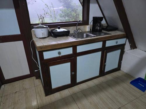 a kitchen with a sink and a window at private and pleasant in Zapotal