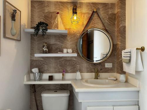 a bathroom with a sink and a mirror at Remodeled Margarita Apt Pool in Porlamar