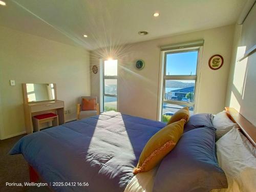 a bedroom with a bed with two pillows on it at Waterview Spacious Bliss - 2 Beds in Porirua