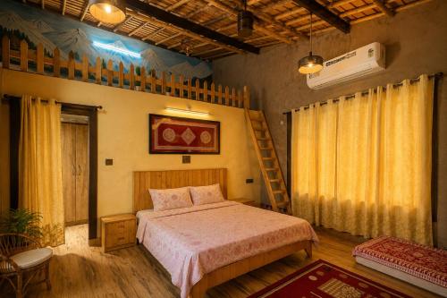 a bedroom with a bed and a ladder in it at Ramashray - Mud House Living in Haldwāni