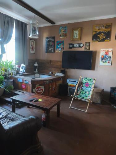 a living room with a couch and a table at Druhý domov in Podmokly