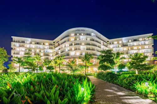 a large white building with trees in front of it at SOL by Meliá Phu Quoc in Phú Quốc