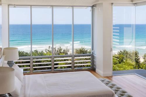 a bedroom with a large window view of the ocean at The Beach Shack: Getaway on Sunshine Beach in Noosa Heads