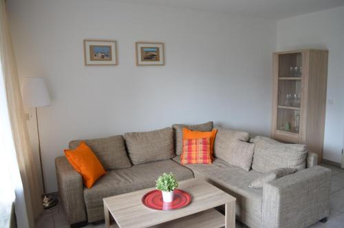 a living room with a couch and a table at Wangeroogeweg 27 in Schillig