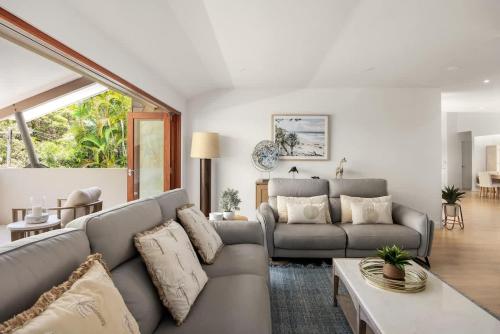 a living room with a couch and a table at Sunshine Beach Retreat, Pool, Backyard in Sunshine Beach