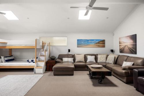 a living room with a couch and a bunk bed at Sunshine Beach Retreat, Pool, Backyard in Sunshine Beach
