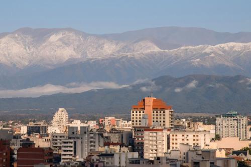 a city with mountains in the background with buildings at Hotel Alejandro I, Affiliated by Meliá in Salta