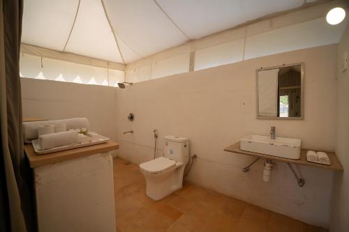 a bathroom with a toilet and a sink at Jaisalmer Sand Dunes Resort in Jaisalmer