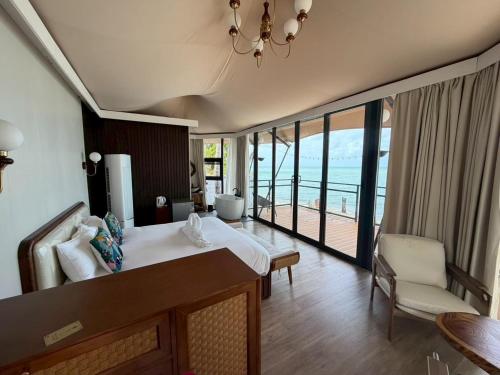 a bedroom with a bed and a view of the ocean at Umbrella tree V4 in Nathon