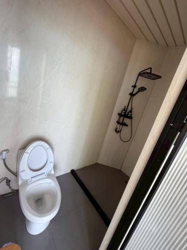 a small bathroom with a toilet in a stall at Umbrella tree V4 in Nathon
