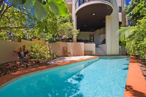 a swimming pool in front of a building at Beach Luxury, Ocean Views & Pool in Noosa Heads