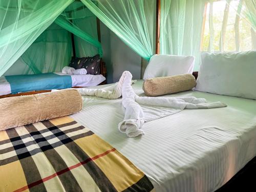 a large bed in a tent with two beds at Green Tree House Yala in Yala