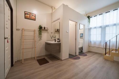 a bathroom with a sink and a mirror at Siam Place - Spacious Family House in Bangkok in Bangkok