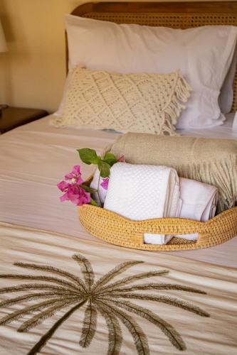 a bed with towels and flowers on it at Seraya Villas in Kuta Lombok