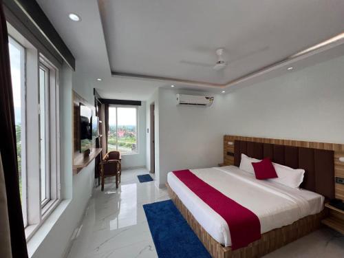 a bedroom with a bed and a large window at Hotel Surya Inn in Kānsrao