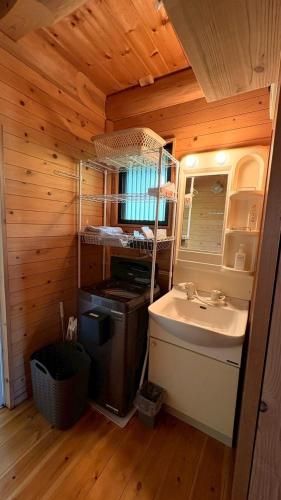 a small bathroom with a sink and a sink at Karin in Minami Aso