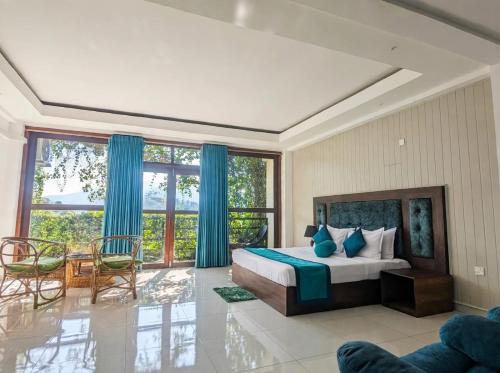 a bedroom with a bed and a table and chairs at Ella Dream Mount in Ella