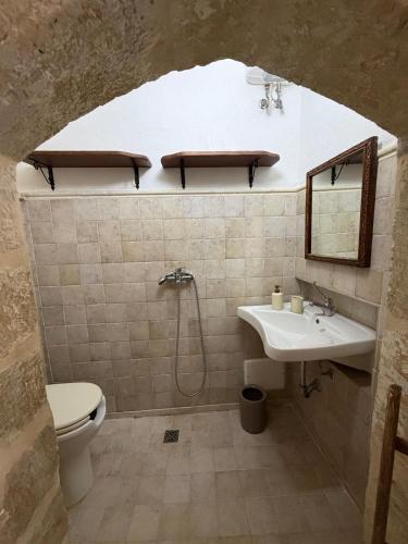 a bathroom with a sink and a toilet at B&B Vernole1713 in Vernole
