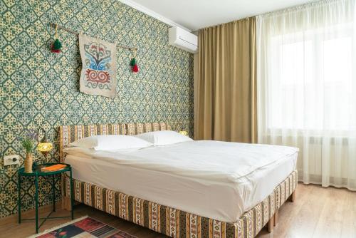 a bedroom with a large bed in a room at Ordo Hotel in Karakol