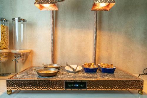 a buffet with bowls of food on a table at Ordo Hotel in Karakol