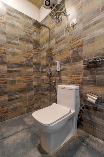 a bathroom with a toilet in a room at Prideinn Luxury Resort in Rishīkesh