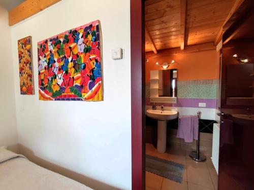 a bathroom with a painting on the wall and a sink at Brojo Hill in Longare