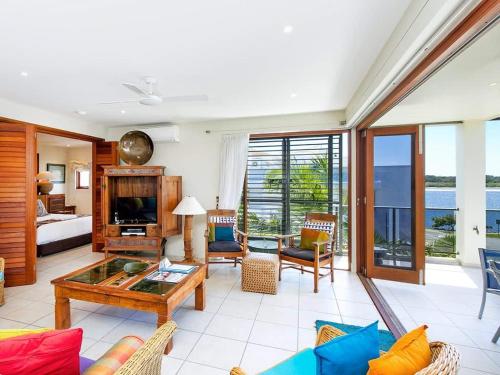 a living room with a couch and a table at Noosa Dua 2 Balinese Retreat in Noosa Heads