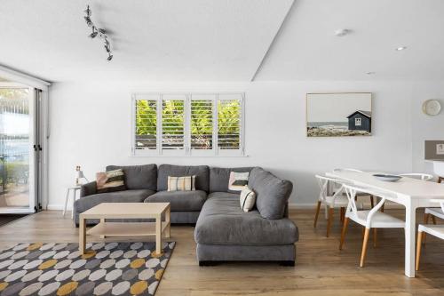 a living room with a couch and a table at Noosa Haven Apt 6 Riverside Retreat in Noosaville