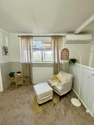 a living room with a couch and a window at Backyard Bliss in Waikerie