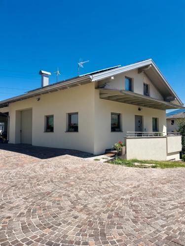 a house with a brick driveway in front of it at Mirtillo in Tassullo